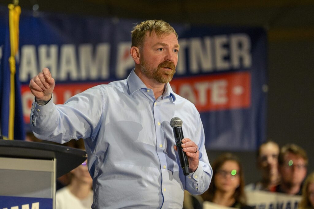 Maine's Graham Platner is the Democratic candidate for what's considered the nation's most competitive battle for the U.S. Senate. Platner, who is challenging incumbent Sen. Susan Collins, is shown at a rally at the Holiday Inn by the Bay in Portland on April 18, 2026. (Photo by Jim Neuger/ Maine Morning Star)