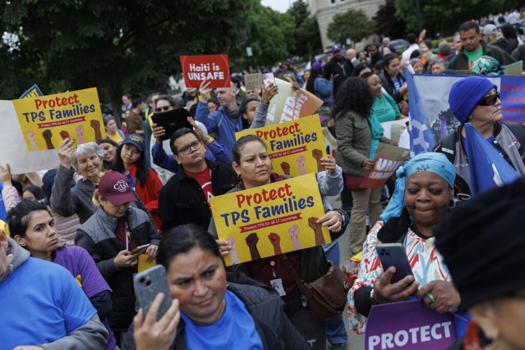 Demonstrators chant and hold signs outside U.S. Supreme Court on April 29, 2026 in Washington, DC. The court heard arguments challenging the government's termination of Temporary Protected Status for immigrants. (Photo by Tom Brenner/Getty Images)