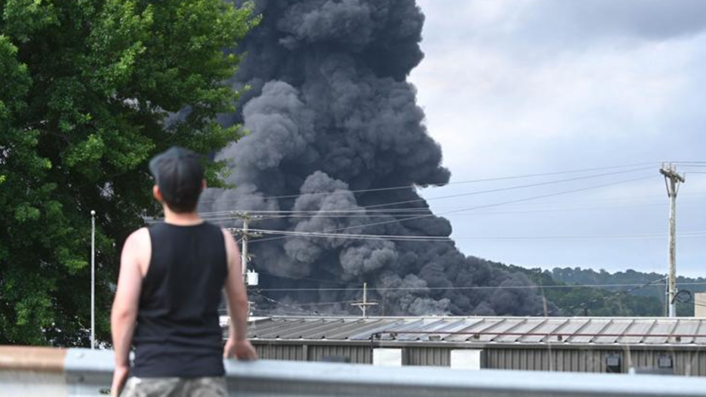 Photo By Esteban Fernandez | Caleb Cheadle, a Parkersburg resident, watches smoke billow from the Peoples Cartage warehouse fire on July 5, 2026.